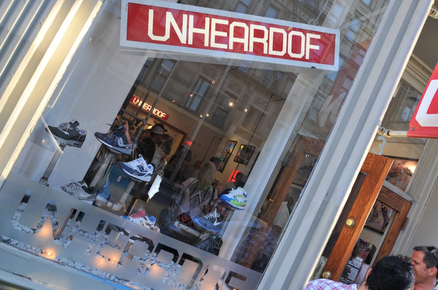 The Unheardof storefront sign hanging above the entrance on a Downtown Cincinnati street.